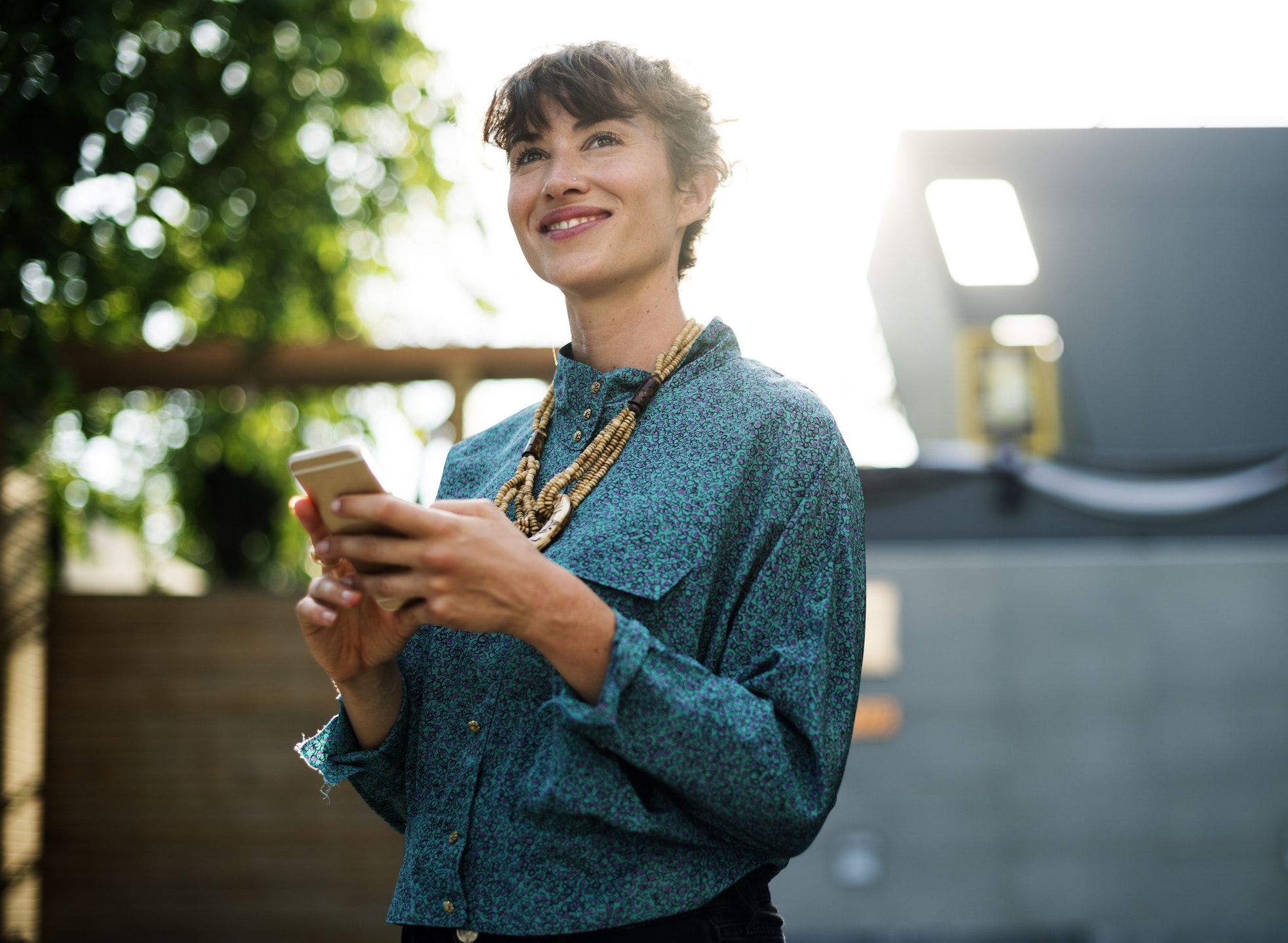 smiling woman holding smartphone